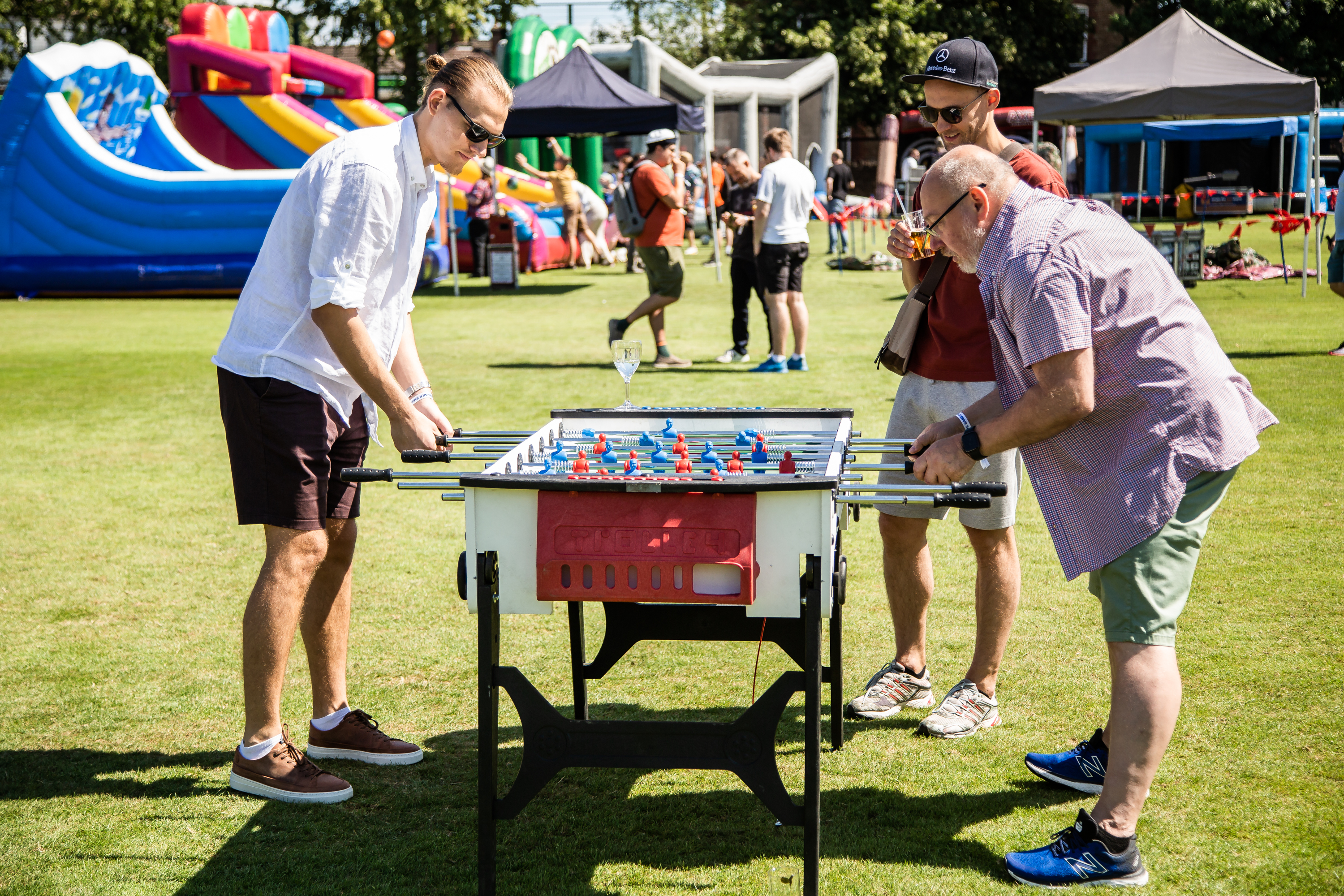 Colleagues playing table football at the Summer Party